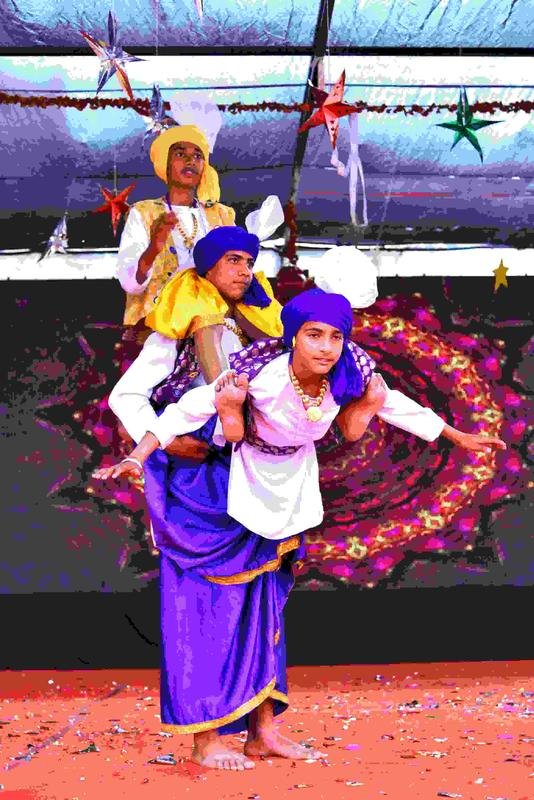 Students forming a bhangra pyramid on stage